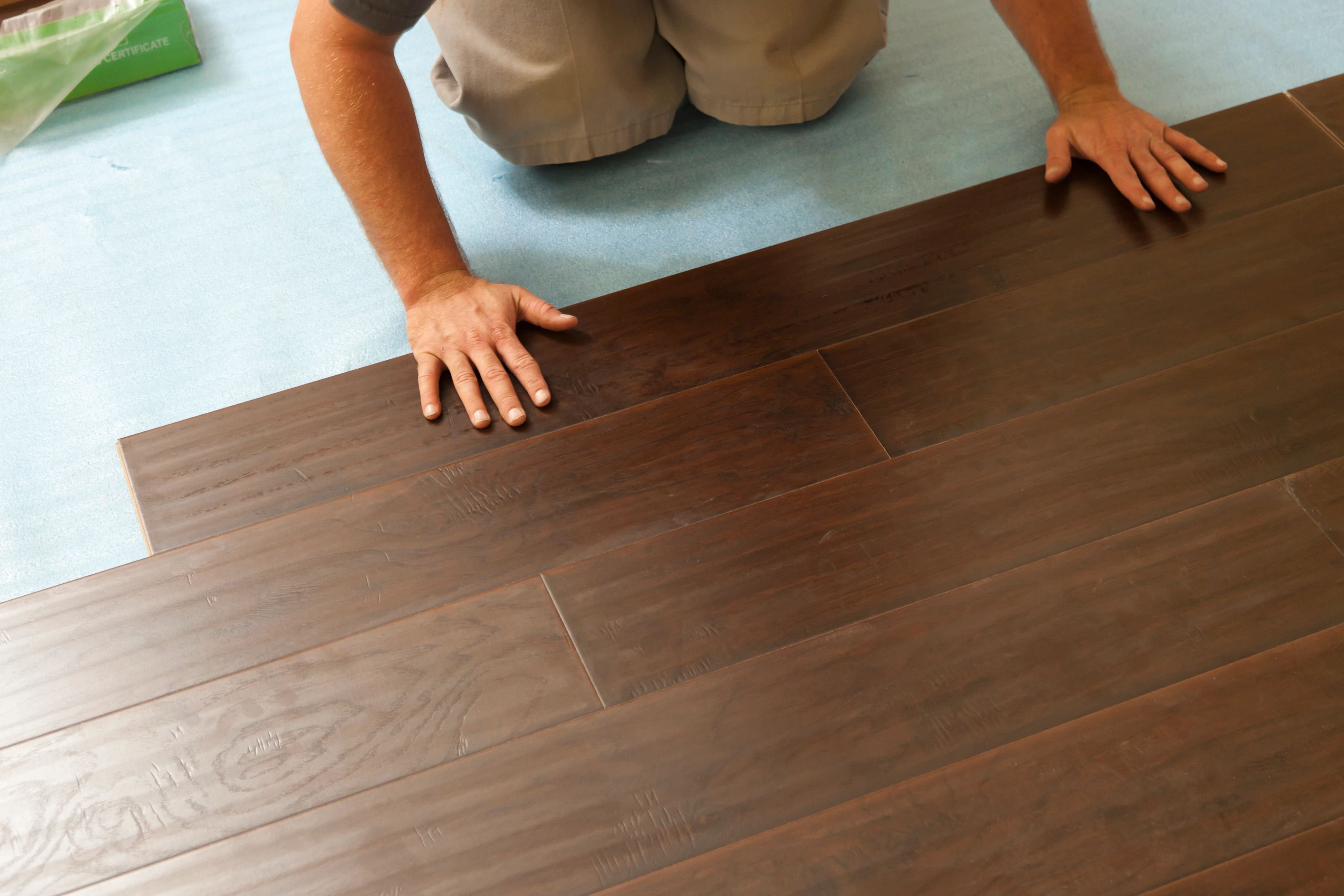 Person installing hardwood flooring from Triangle Flooring Center in Carrboro, North Carolina
