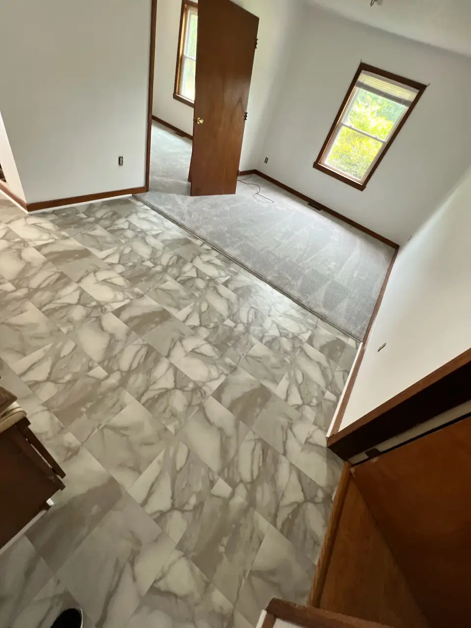 Triangle Flooring - Kitchen tile floor installation with transition to carpet