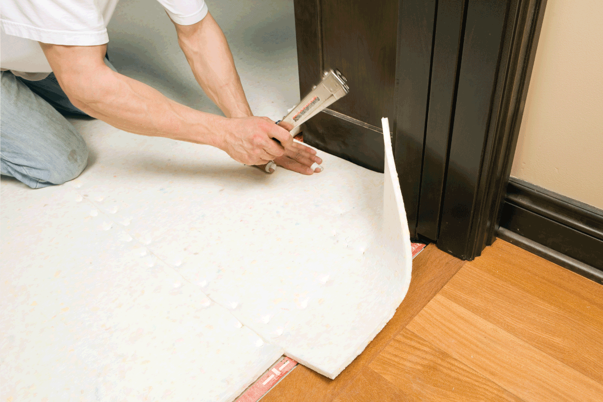 Person installing flooring underlayment from Triangle Flooring Center in Carrboro, North Carolina